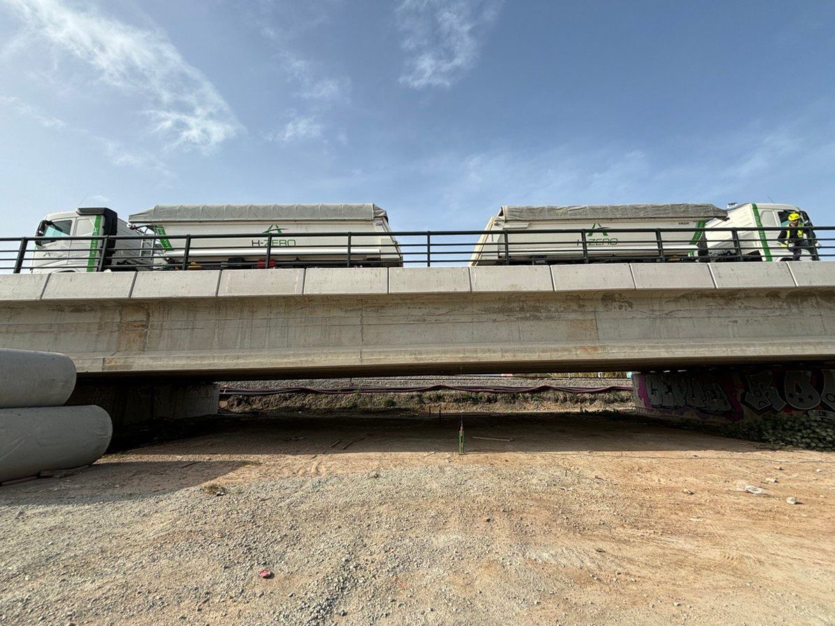 Ballast trucks positioned on the deck during a controlled load test.